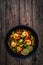 Shrimps, rice noodles, broccoli and shimeji mushrooms on wooden table