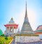 The shrines and chedi of Wat Arun temple, decorated with colorful porcelain, Bangkok, Thailand