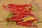 Shrinking and mould chili peppers on wooden background. Rotten chili peppers. Flat design