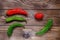 Shriveled stale tomatoes and peppers on a wooden background. Flat layout.