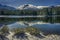 Shrubs and Lassen Peak after snow storm with reflections in Manzanita Lake, Lassen Volcanic National Park