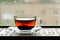 Shu puerh tea brewed in glass cup on window sill