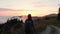 Shuamta, Georgia - 30th july, 2022: back view hiker backpacker on forest trail enjoy dramatic sunset over clouds in remote