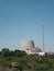 A shut down nuclear power plant with the partially demolished cooling tower