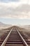 Shut down rail tracks leading to the horizon in Salar de Uyuni, Bolivia