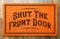 Shut the Front Door Orange Welcome Mat On Wood Floor Background