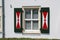 Shutters on Dutch windows with traditional red and white design