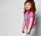 Shy smiling cutie smiling little toddler girl in sportswear studio shot