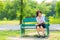 Shy Thai schoolgirl sitting on a bench