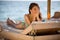Shy woman peeking through covered face.Funny beautiful woman sunbathing in a bikini on a beach at travel resort,enjoying summer ho