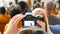 Si RACHA, THAILAND - JANUARY 17, 2018: Viewers with smartphone and tablets shoot the show of elephants on a video camera