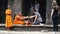 Siam Reap Angkor Wat, Cambodia - January 12, 2017:Cambodian buddhist monk reading mantra for tourist. Tourists and