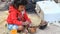 Siam Reap, Cambodia - January 14, 2017: A small Cambodian girl plays next to garbage and waste. Life in the slums and