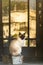 Siamese Cat Sits on Wood Block on Front Porch