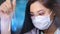 Ðsian female medical technologist in glasses and mask creating pharmacy preparation in laboratory