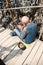 SIAULIAI, LITHUANIA - JULY 28, 2019: Hill of Crosses is a unique monument of history and religious. Homeless man begging for alms