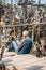 SIAULIAI, LITHUANIA - JULY 28, 2019: Hill of Crosses is a unique monument of history and religious. Homeless man begging for alms