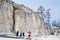 Siberia, Irkutsk region, cape Sagan-Zaba, Russia, March, 10, 2017.Tourists walking on the coast of lake Baikal. Mountain landscape