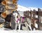 Siberian Husky resting on the snow near wooden house.