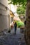 Sibiu, Romania - 2019. Young girl wandering on an old street with cobblestone pavement and colorful houses in Sibiu