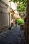 Sibiu, Romania - 2019. Young girl wandering on an old street with cobblestone pavement and colorful houses in Sibiu