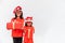 Sibling Asian girls in red Santa hat with gift boxes on white background