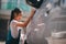 Sibling Asian girls wash their cars and have fun playing indoors on a hot summer day