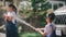 Sibling Asian girls wash their cars and have fun playing indoors on a hot summer day