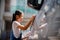 Sibling Asian girls wash their cars and have fun playing indoors on a hot summer day