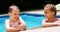 Sibling enjoying in swimming pool