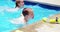 Sibling enjoying in swimming pool