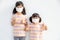Sibling Little girl wearing a mask to stop coronavirus outbreak.Quarantine Asian sibling.Covid-19 coronavirus and pandemic virus