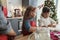 Siblings baking gingerbread cookies in domestic kitchen