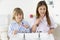 Siblings Brushing Teeth Together at Sink