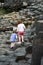 Siblings climbing the rocks at Giant`s Causeway