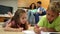 Siblings colouring on the floor while their parents are sitting on sofa