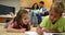 Siblings colouring on the floor while their parents are sitting on sofa