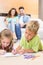 Siblings colouring on the rug with parents watching from sofa