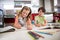 Siblings doing homework in kitchen