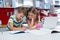 Siblings doing homework in kitchen