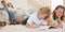 Siblings doing their homework on the carpet