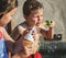 Siblings enjoy blowing bubbles outdoors