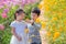 Siblings enjoy together in flower garden