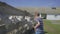 Siblings feeding goats through the fence. Kids are happy to play with domestic animals on goat farm. Two boys give food