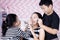 Siblings having time doing face painting to mother
