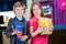 Siblings Holding Popcorn And Drink At Cinema