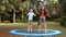 Siblings jumping on a trampoline