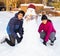 Siblings Making a Snowman