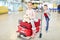 Siblings play with their luggage in the airport