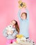 Siblings playful hold teddy bear plush toys. Boy and girl play with soft toys teddy bear on pink background. Bears toys